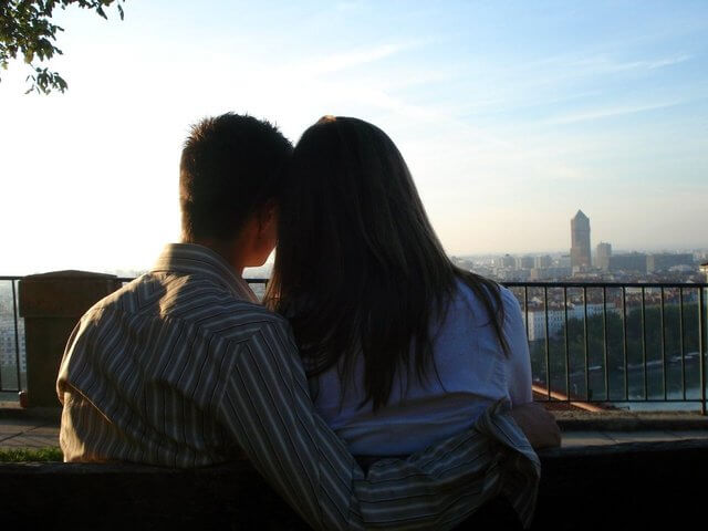 a couple sitting and watching a view