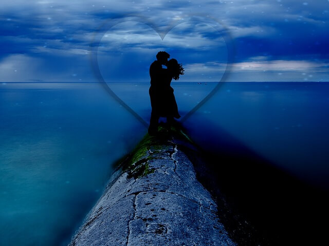 couple kissing in a beautiful ocean view.