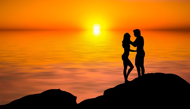 lovers kissing during a sunset