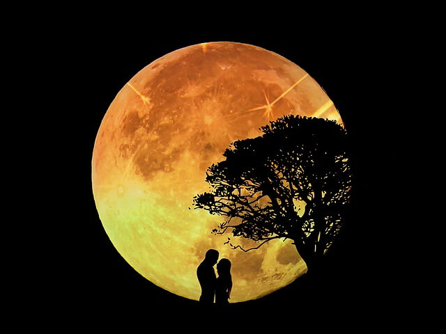 lovers kissing during full moon