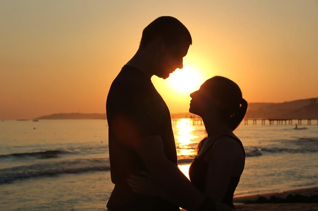couple making eye contact during sunset.