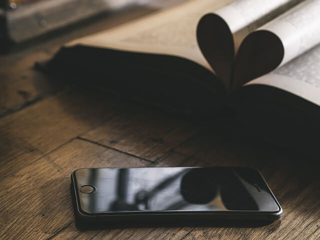 a phone sitting on a wooden table